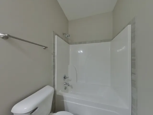 a bathroom with a toilet and a bathtub