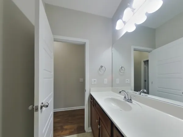 a bathroom with a double vanity sink and a mirror