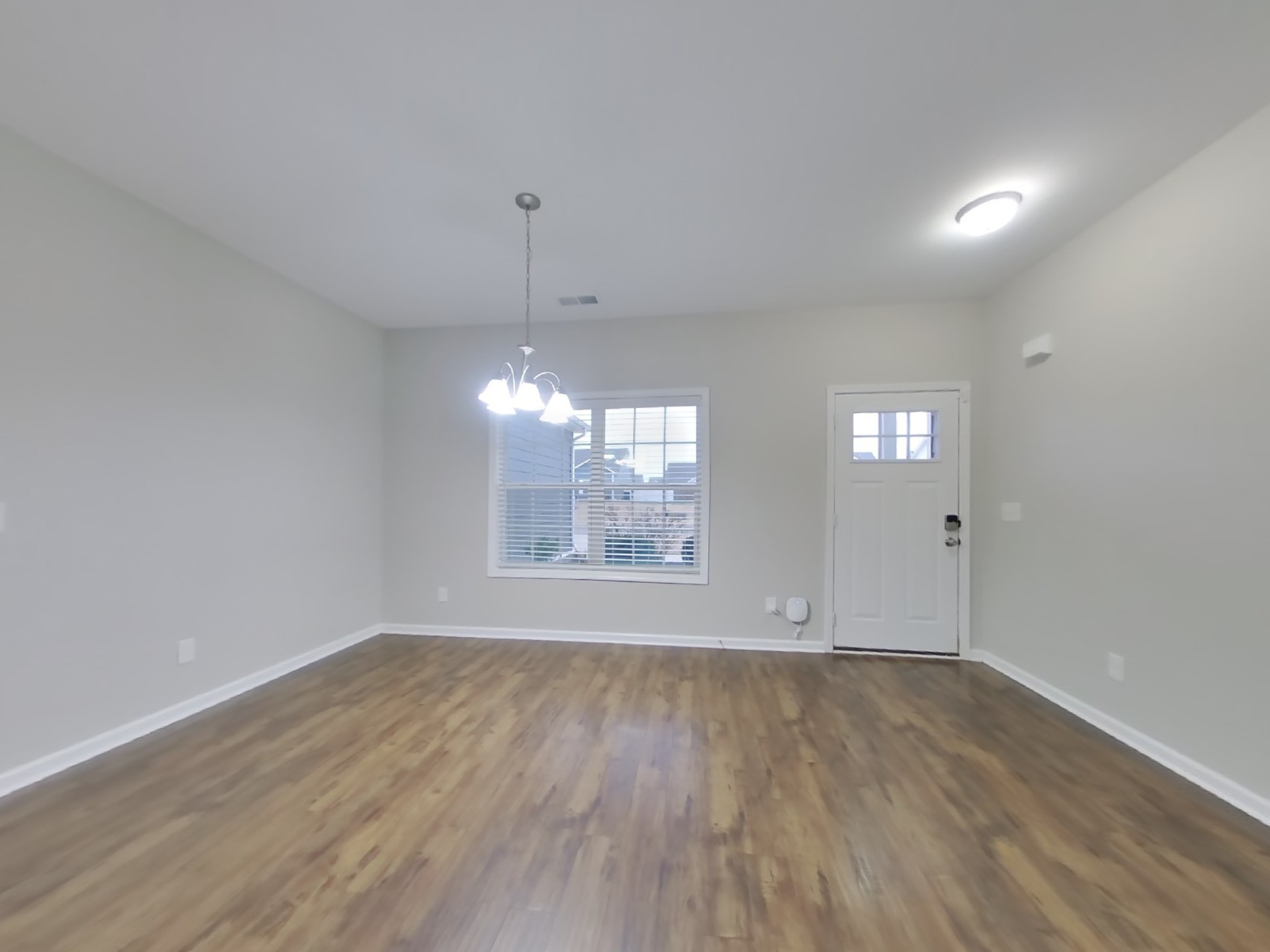 809 Ellyson Drive Spring Hill, TN 37174 - Photo 2 of 17 an empty room with wooden floor and windows