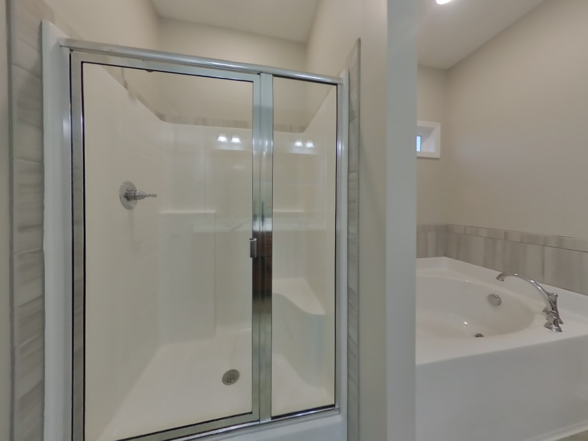 809 Ellyson Drive Spring Hill, TN 37174 - Photo 9 of 17 a bathroom with a glass shower door and a bathtub