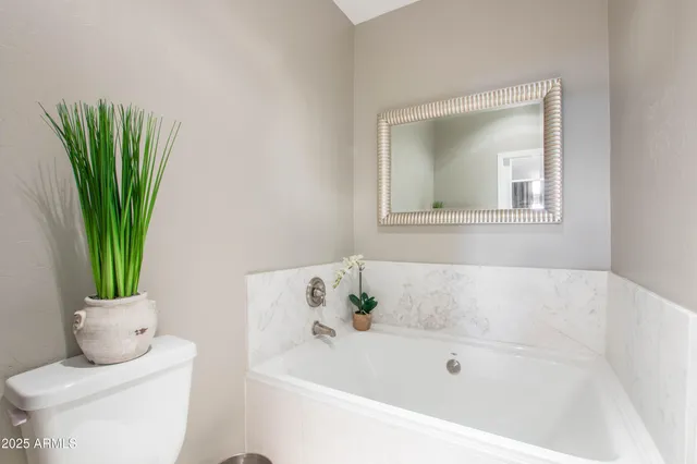 a white bath tub sitting in a bathroom