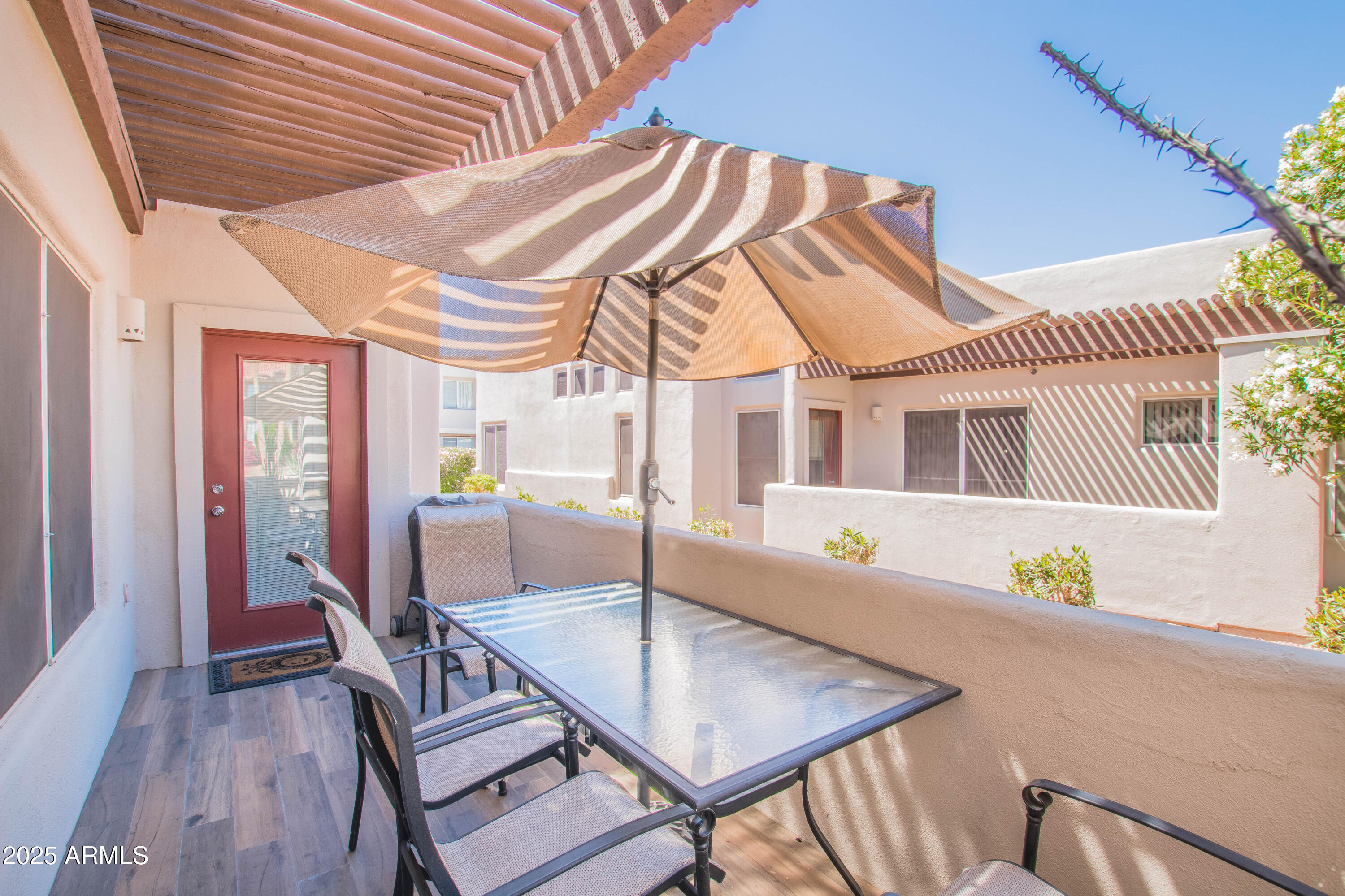 11260 North 92nd Street, Unit 1107 Scottsdale, AZ 85260 - Photo 16 of 20 a dining room with furniture and wooden floor