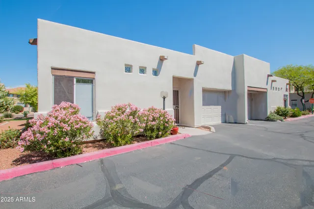 a front view of house with flower around