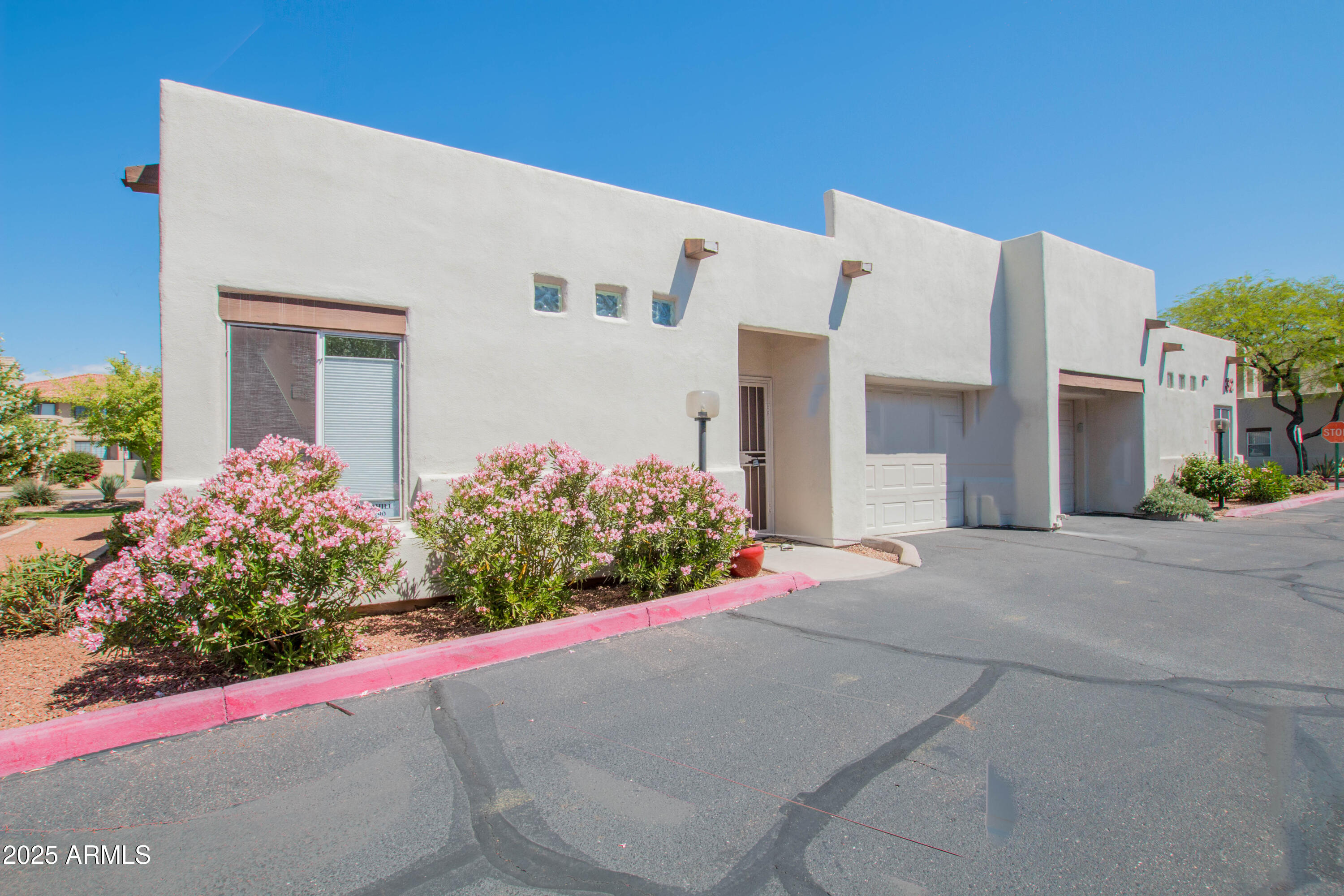 11260 North 92nd Street, Unit 1107 Scottsdale, AZ 85260 - Photo 2 of 20 a front view of house with flower around