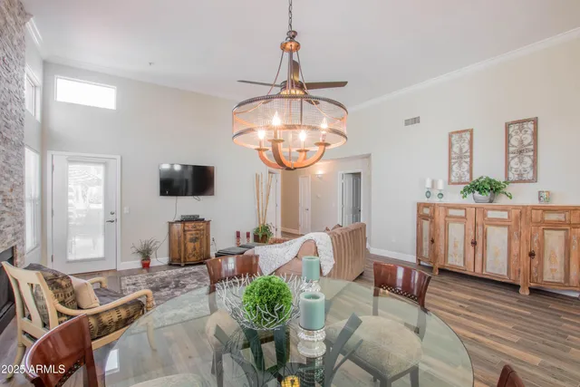 a living room with furniture a dining table and a window