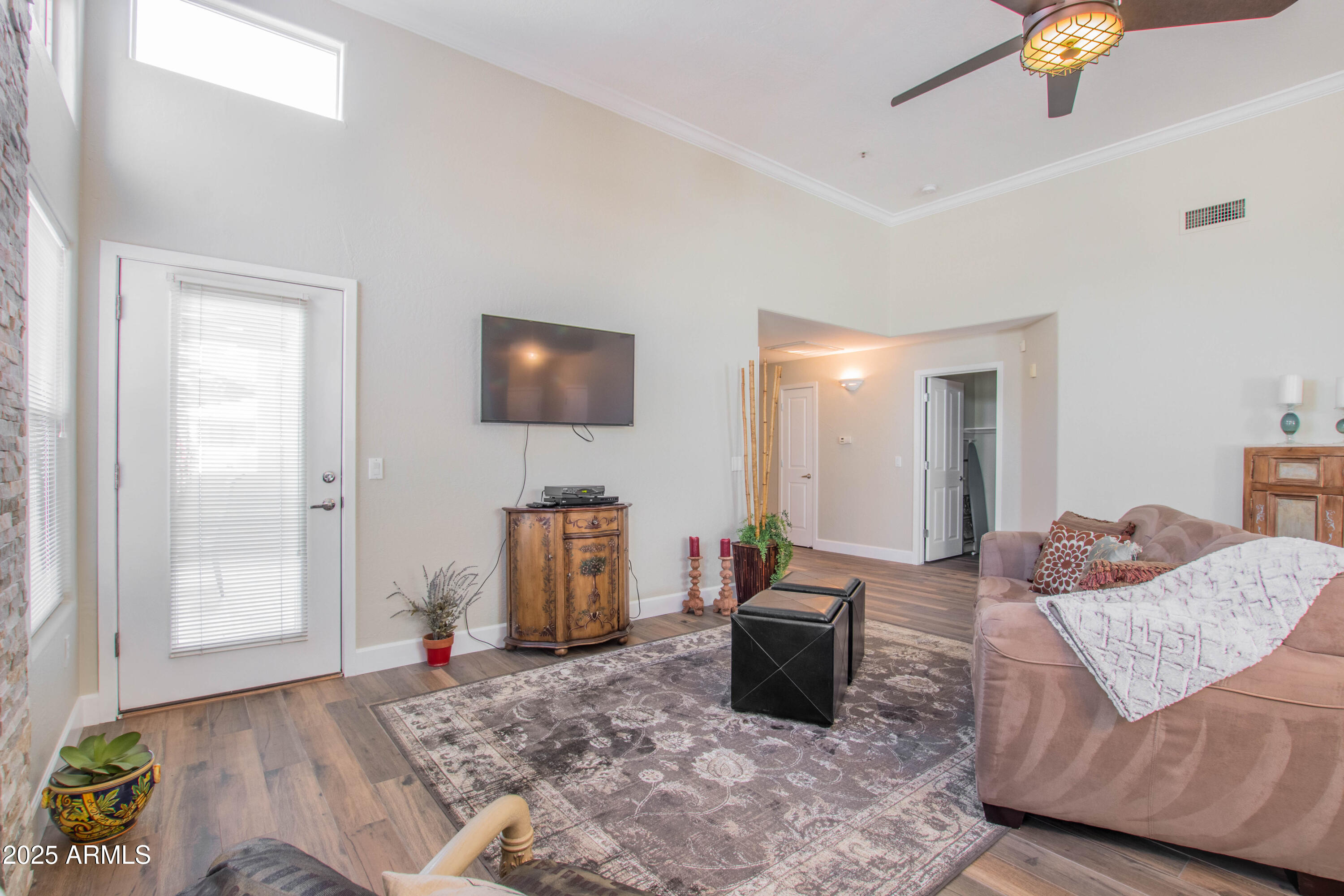 11260 North 92nd Street, Unit 1107 Scottsdale, AZ 85260 - Photo 5 of 20 a living room with furniture and a flat screen tv