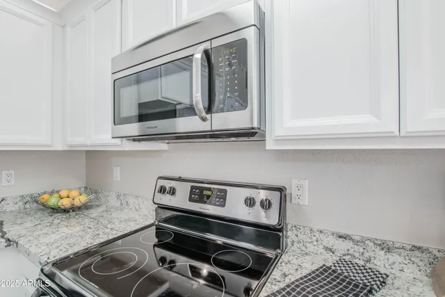 a kitchen with a stove and a microwave