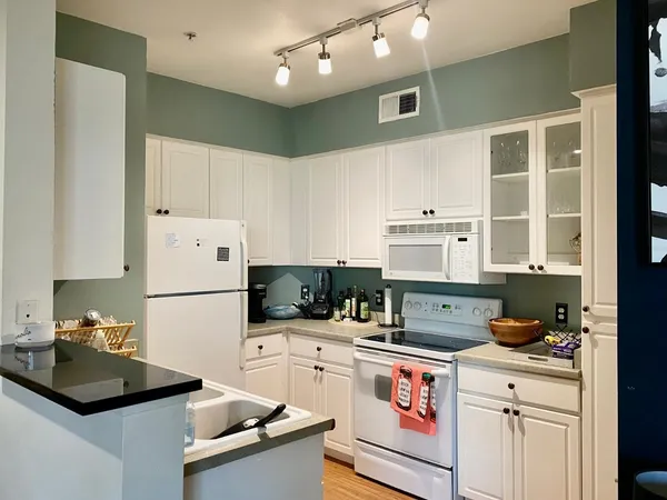 a kitchen with a sink a stove and refrigerator