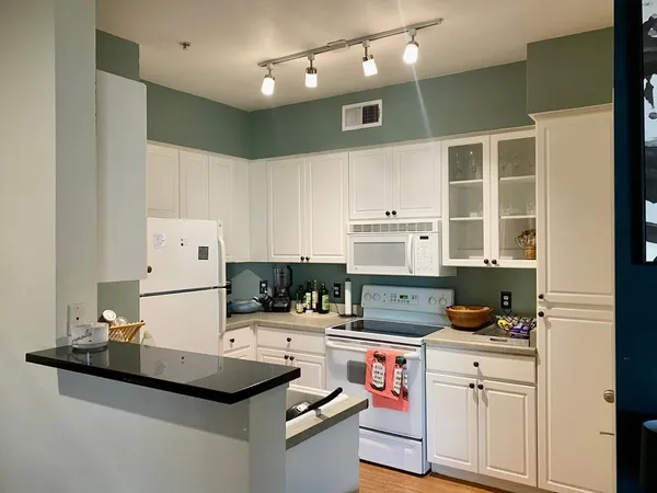 a kitchen with kitchen island a sink stove and refrigerator