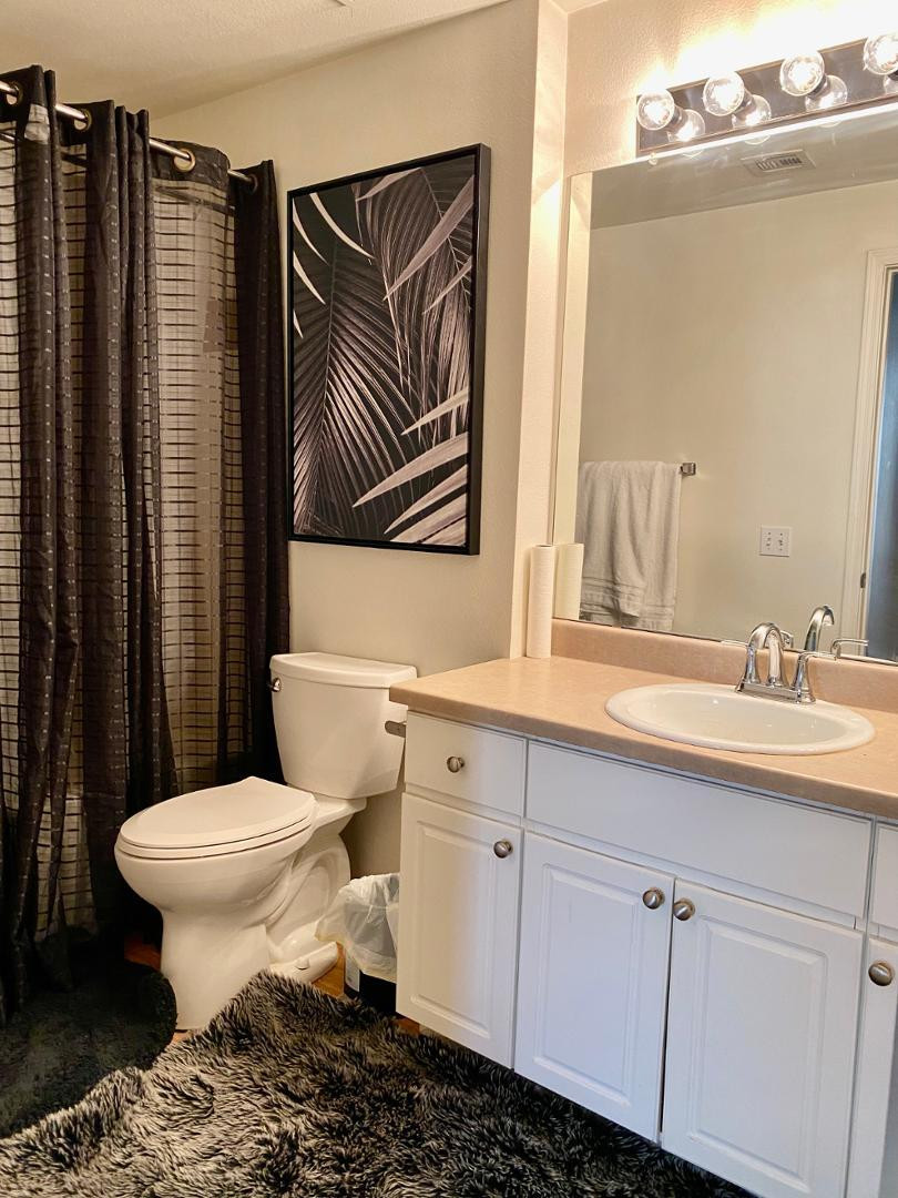 1701 East Colter Street, Unit 388 Phoenix, AZ 85016 - Photo 17 of 22 a bathroom with a sink toilet and mirror