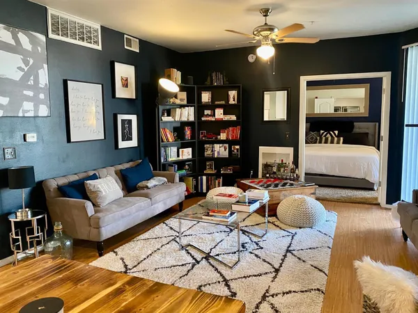 a living room with furniture a lamp and a chandelier