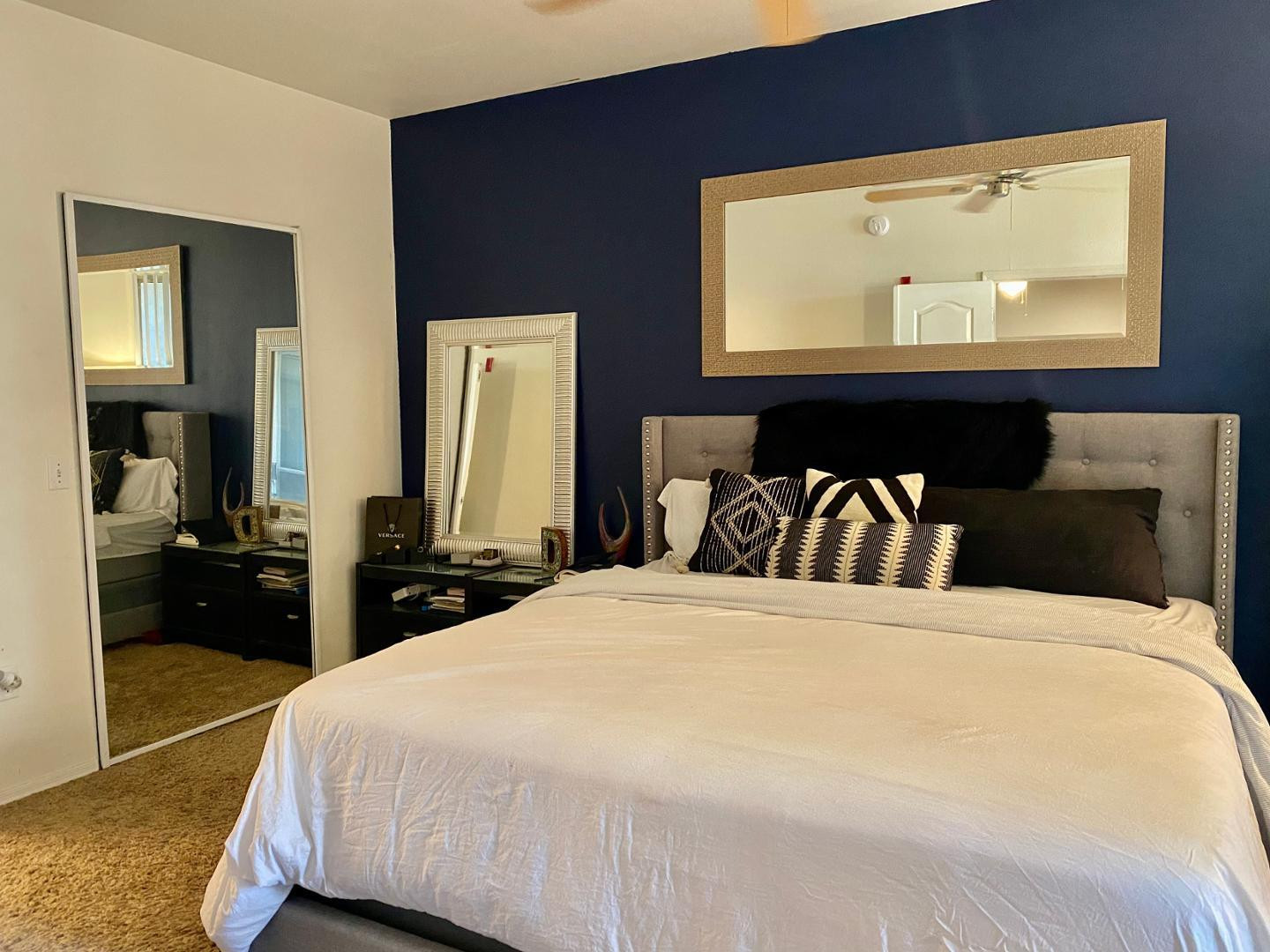 1701 East Colter Street, Unit 388 Phoenix, AZ 85016 - Photo 22 of 22 a bedroom with a bed and a large mirror