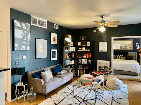 a living room with furniture a lamp and a chandelier