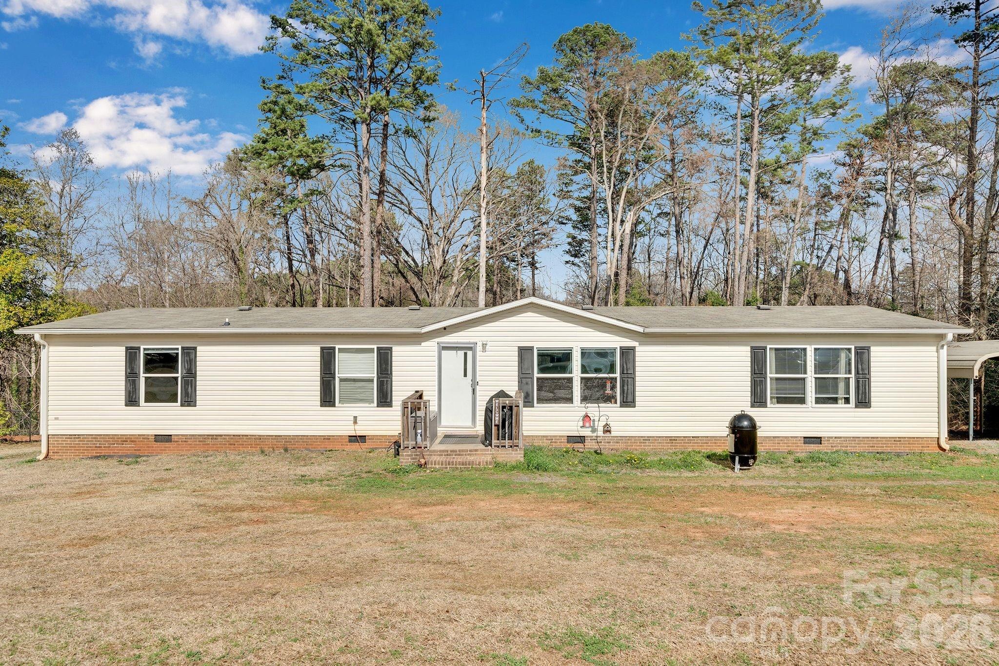 812 Dallas Spencer Mountain Road Dallas, NC 28034 - Photo 1 of 35 a house view with a garden space