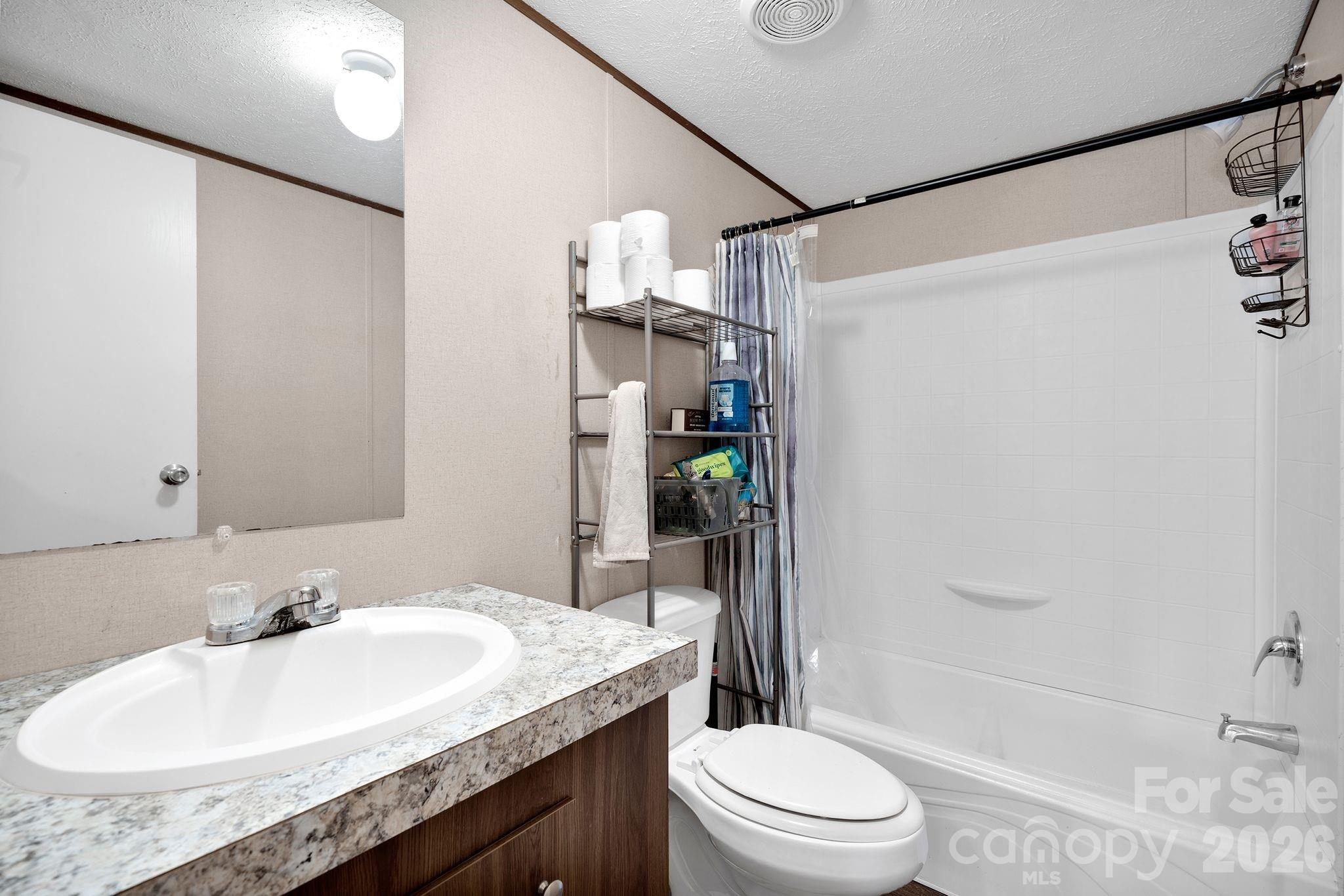 812 Dallas Spencer Mountain Road Dallas, NC 28034 - Photo 15 of 35 a bathroom with a granite countertop sink toilet and shower