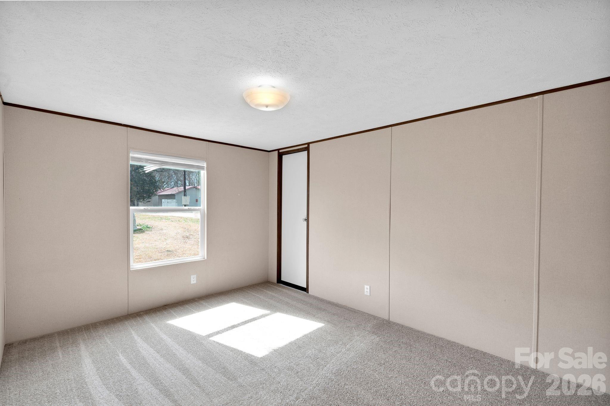 812 Dallas Spencer Mountain Road Dallas, NC 28034 - Photo 16 of 35 a view of an empty room with a window