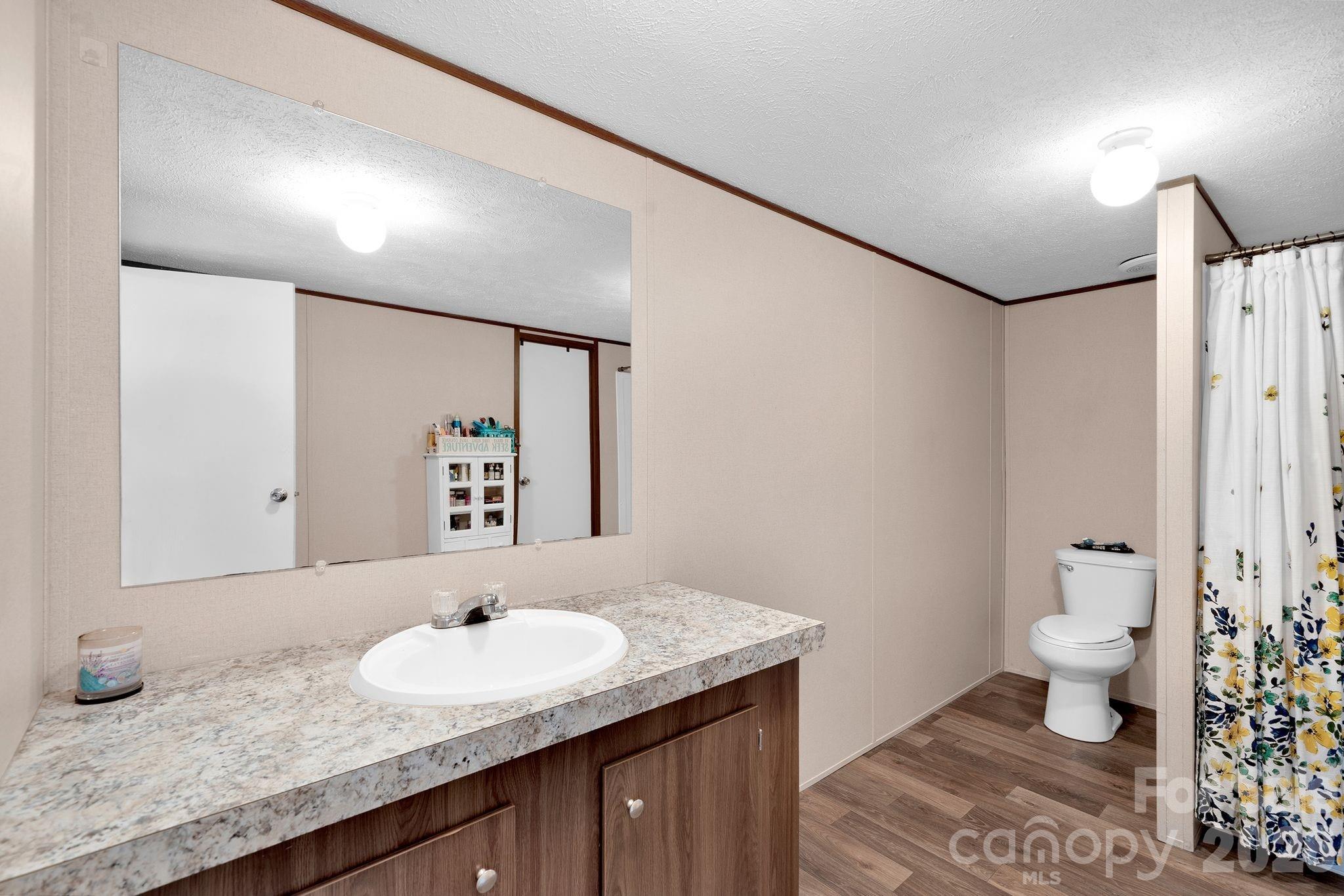 812 Dallas Spencer Mountain Road Dallas, NC 28034 - Photo 25 of 35 a bathroom with a granite countertop sink and a mirror