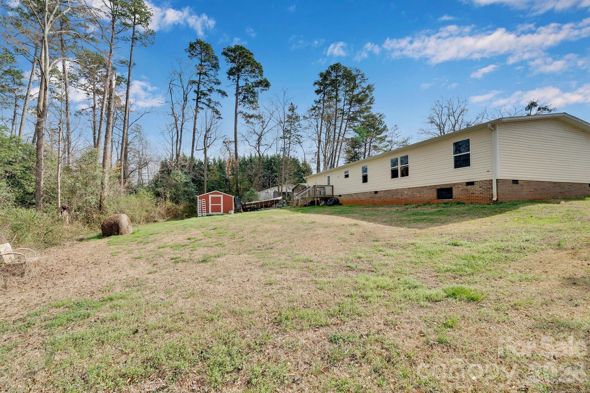 812 Dallas Spencer Mountain Road Dallas, NC 28034 - Photo 30 of 35 a backyard of a house with yard and outdoor seating