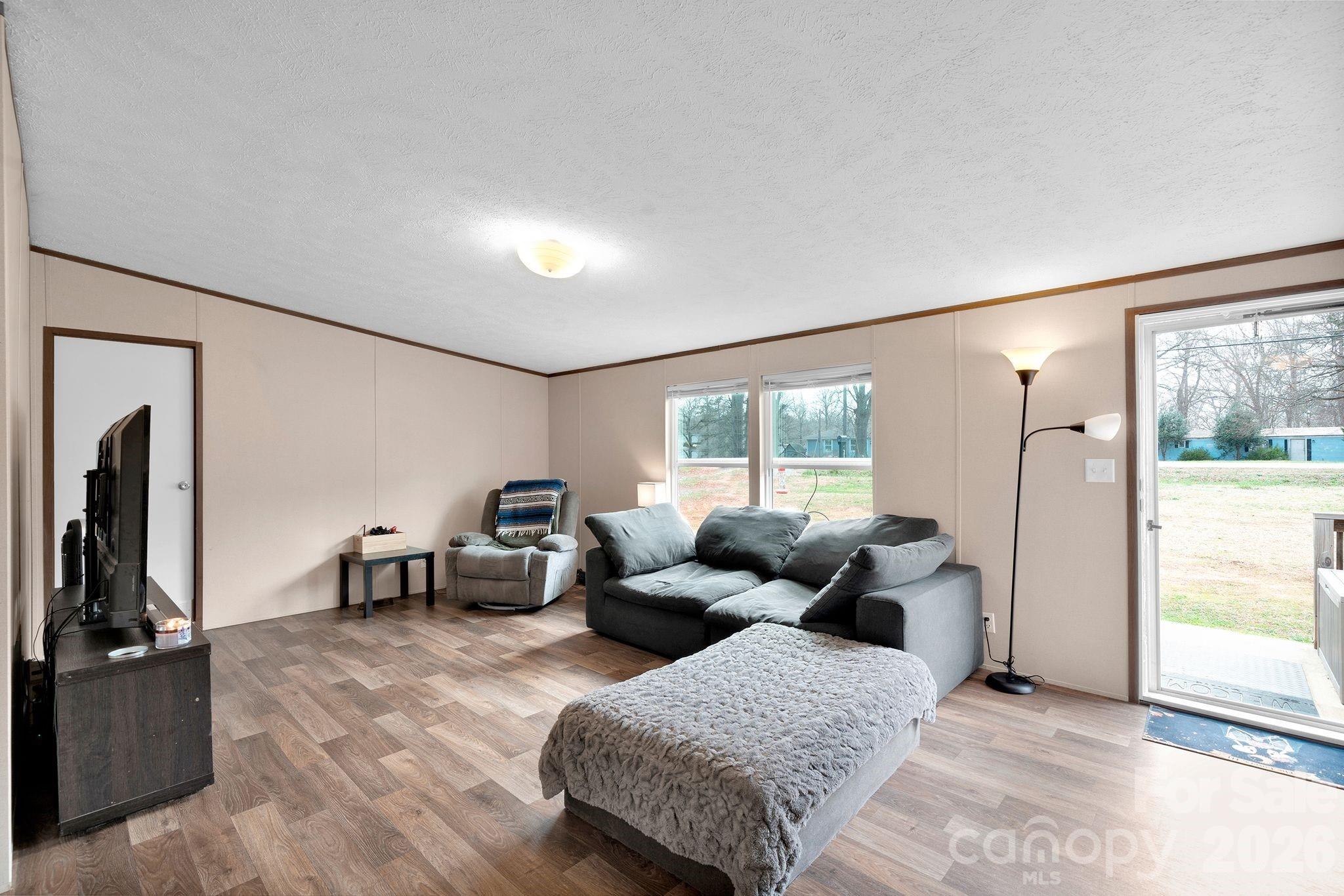 812 Dallas Spencer Mountain Road Dallas, NC 28034 - Photo 3 of 35 a living room with furniture and a flat screen tv