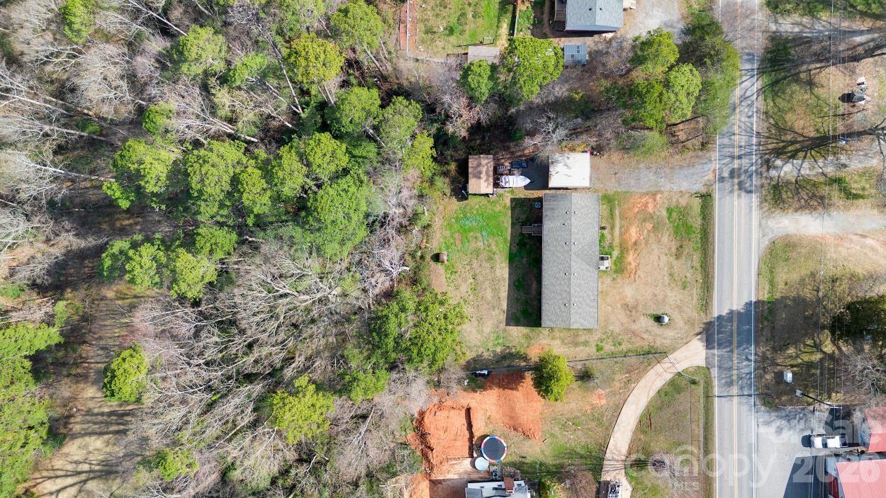 812 Dallas Spencer Mountain Road Dallas, NC 28034 - Photo 32 of 35 an aerial view of a house with a yard and large trees