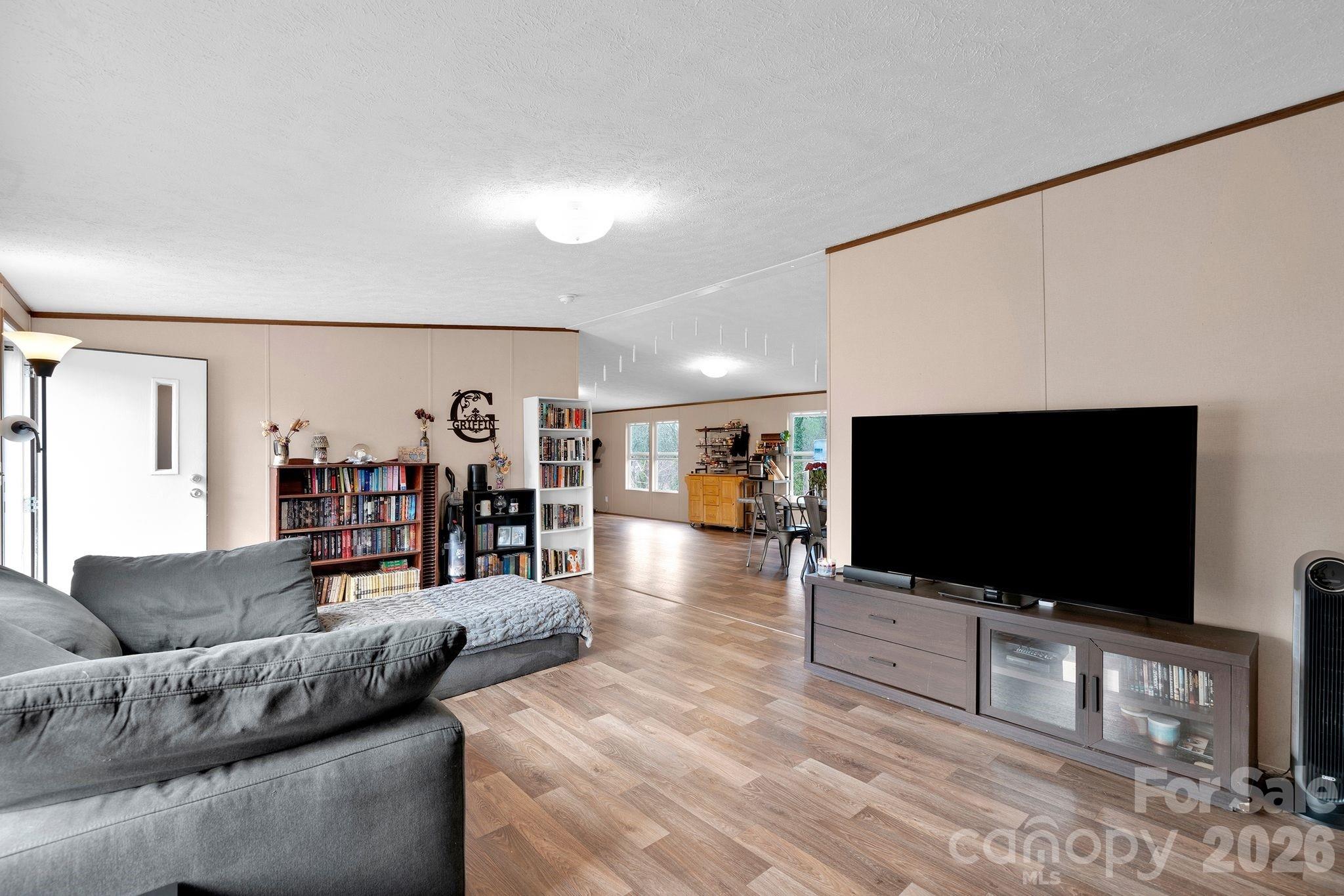 812 Dallas Spencer Mountain Road Dallas, NC 28034 - Photo 5 of 35 a living room with furniture and a flat screen tv