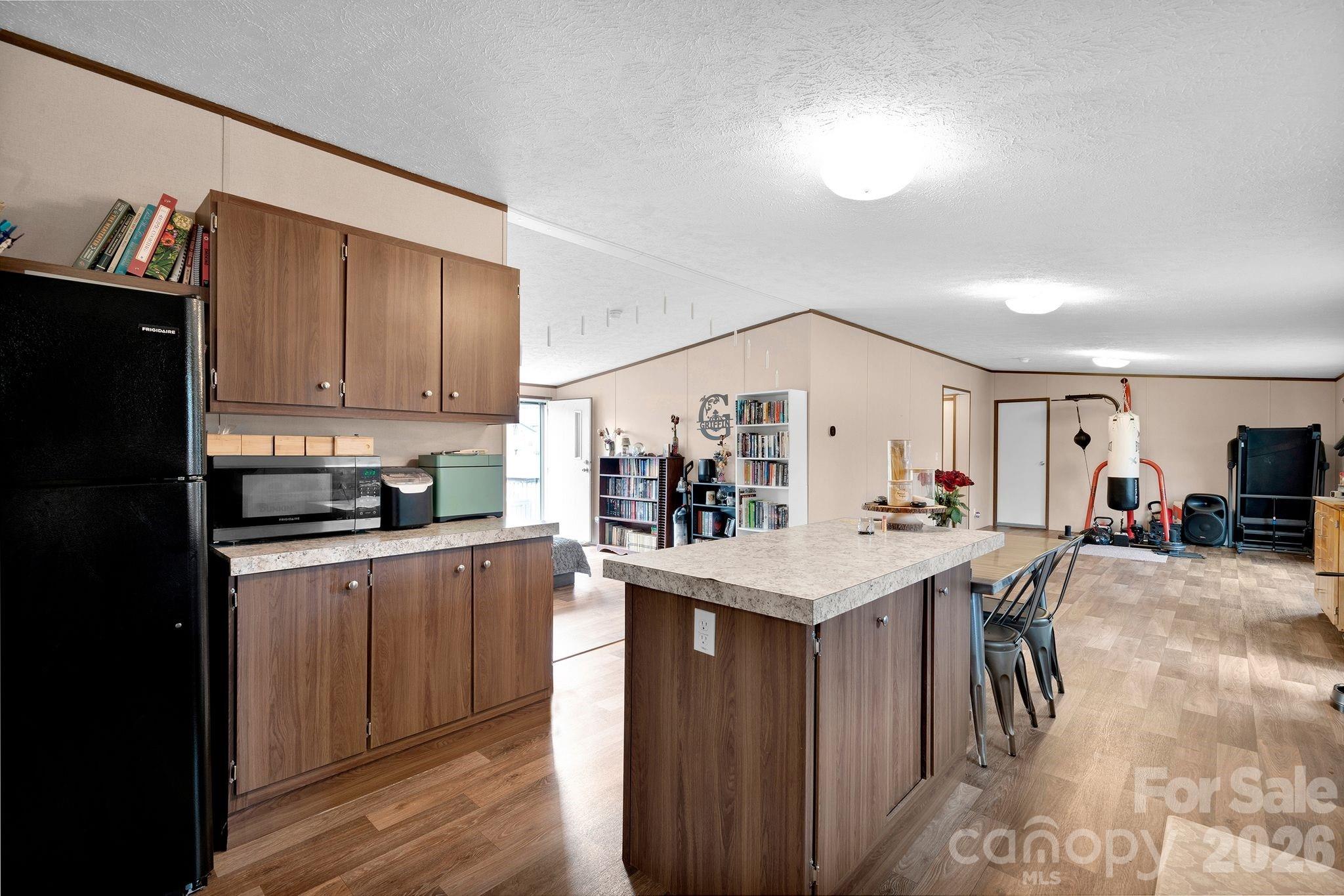 812 Dallas Spencer Mountain Road Dallas, NC 28034 - Photo 8 of 35 a kitchen with stainless steel appliances kitchen island granite countertop a stove refrigerator and cabinets