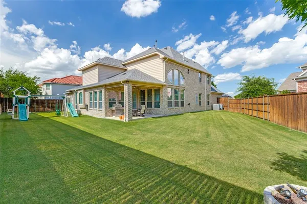 a view of a house with a backyard porch and sitting area