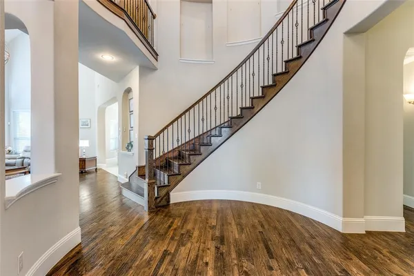 a view of staircase with wooden floor and a rug