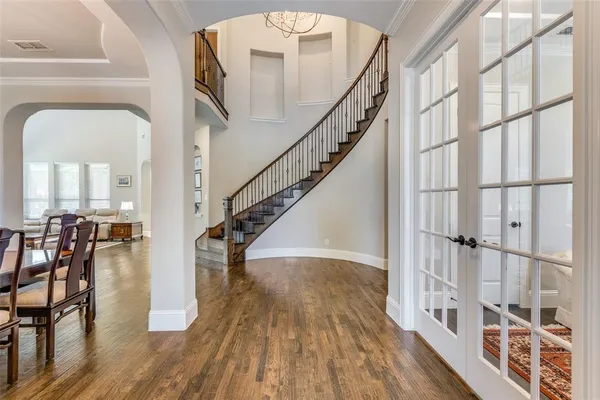 a view of staircase with dining table and wooden floor