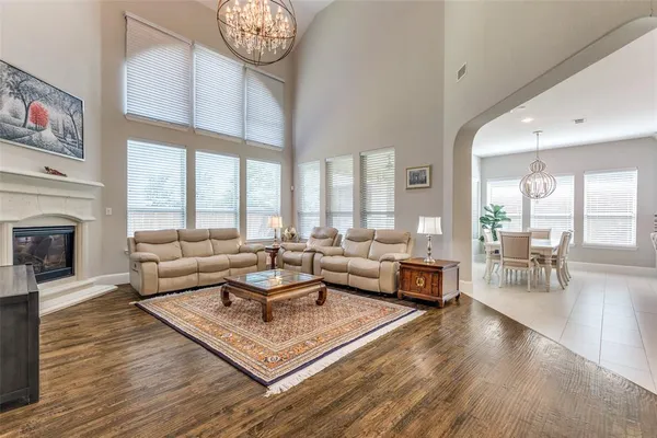 a living room with furniture a large window and a fireplace