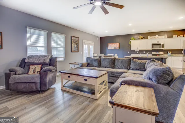 a living room with furniture and a large window
