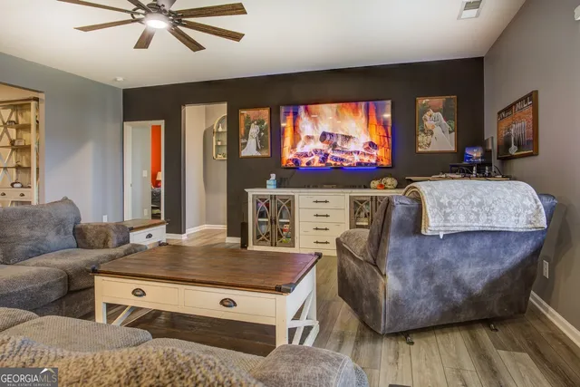 a living room with furniture and a flat screen tv