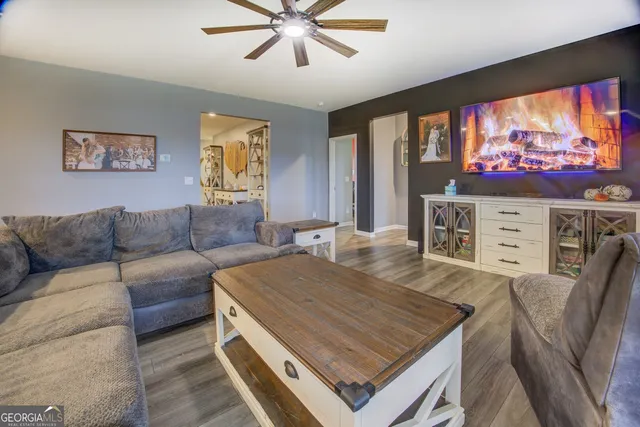 a living room with furniture and a flat screen tv