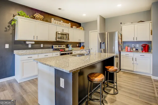 a kitchen with stainless steel appliances a sink and a refrigerator