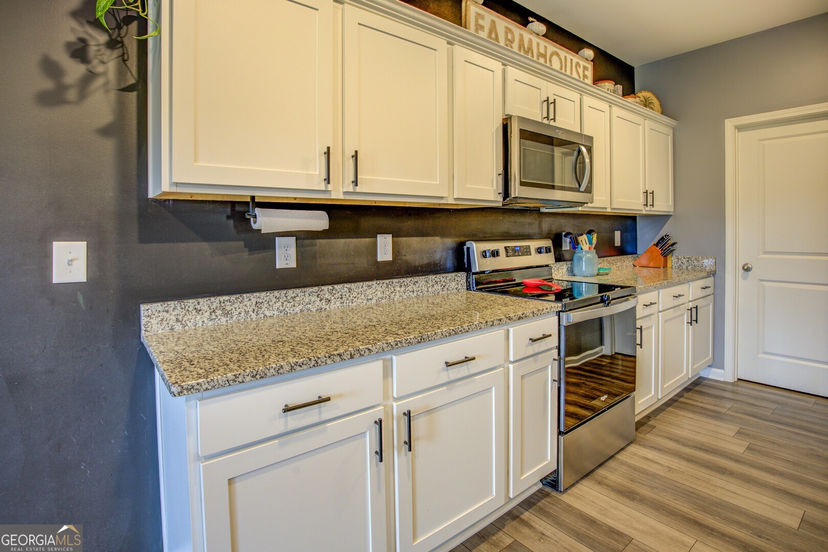 39 Dorsey Way Monroe, GA 30655 - Photo 20 of 44 a kitchen with stainless steel appliances granite countertop a sink and a microwave