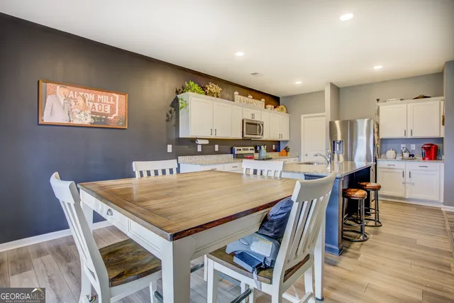 a dining table with chairs and wooden floor