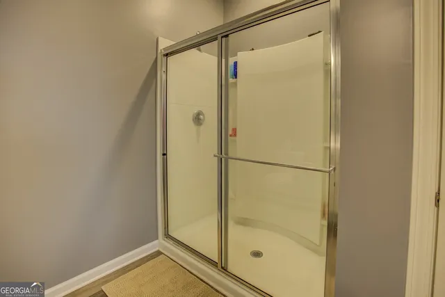 a bathroom with a glass shower door