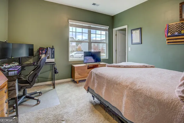 a bedroom with a bed a desk and chair