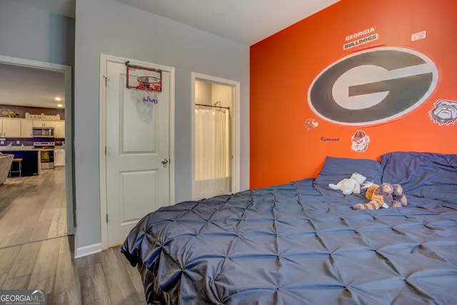 a bed room with a bed and a painting on the wall