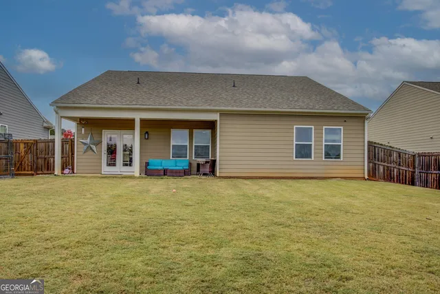 a view of a house with backyard porch and outdoor seating