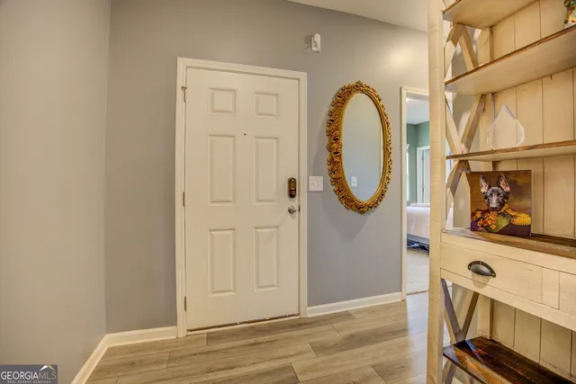 a view of an entryway with wooden floor