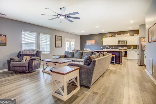 a kitchen with stainless steel appliances granite countertop a sink and a refrigerator