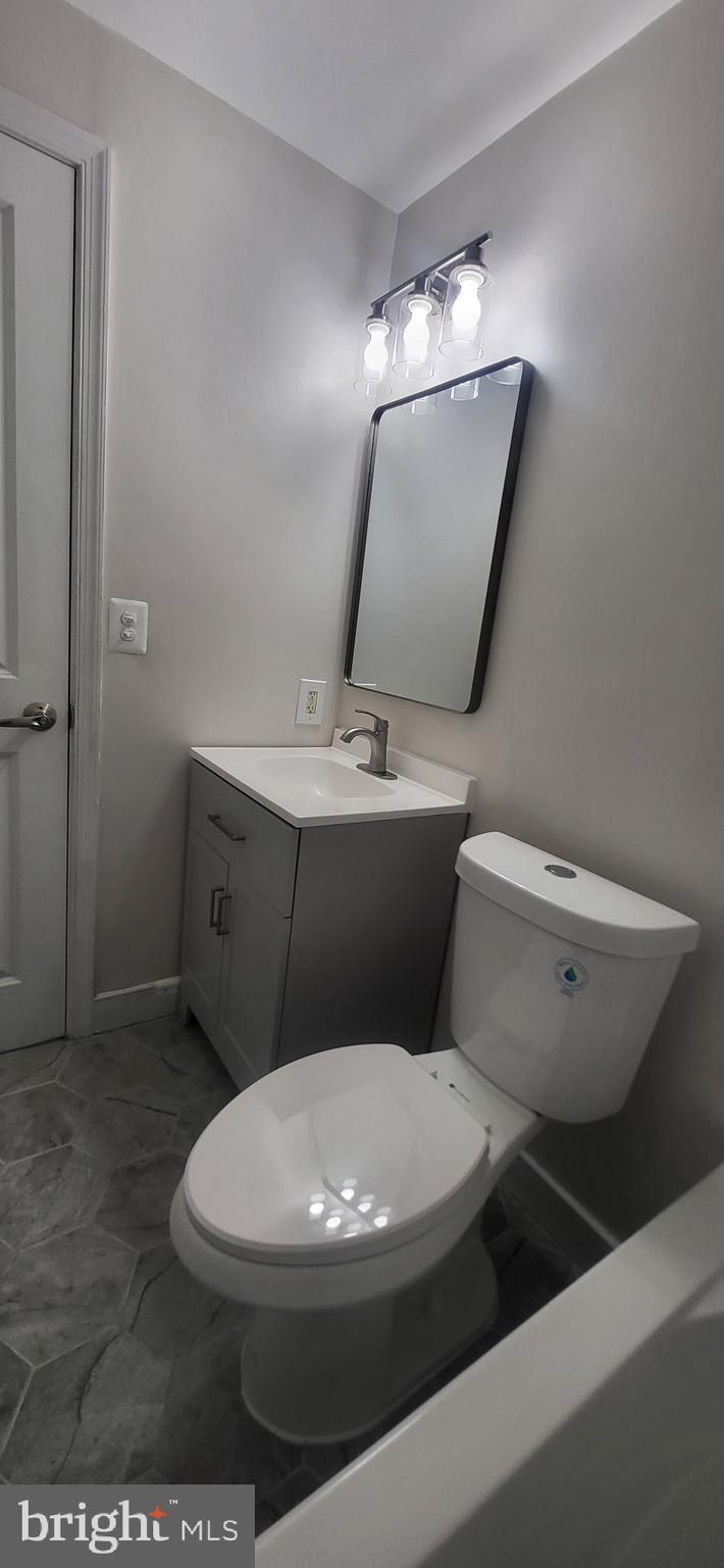 1108 Columbia Road Northwest, Unit 202 Washington, DC 20009 - Photo 16 of 19 a white toilet sitting next to a bathroom sink