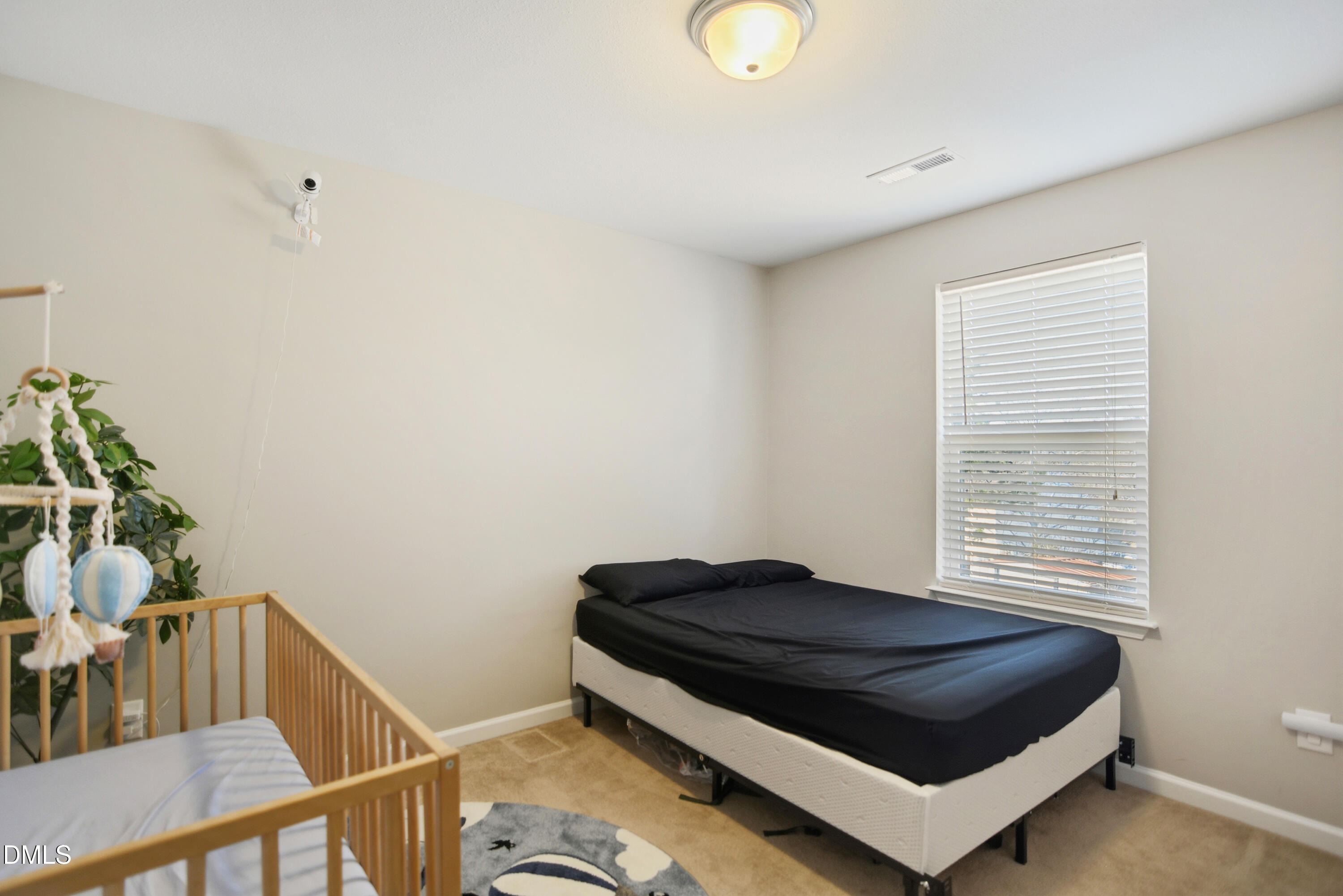Undisclosed Address Durham, NC 27704 - Photo 15 of 21 a bedroom with a bed and a potted plant