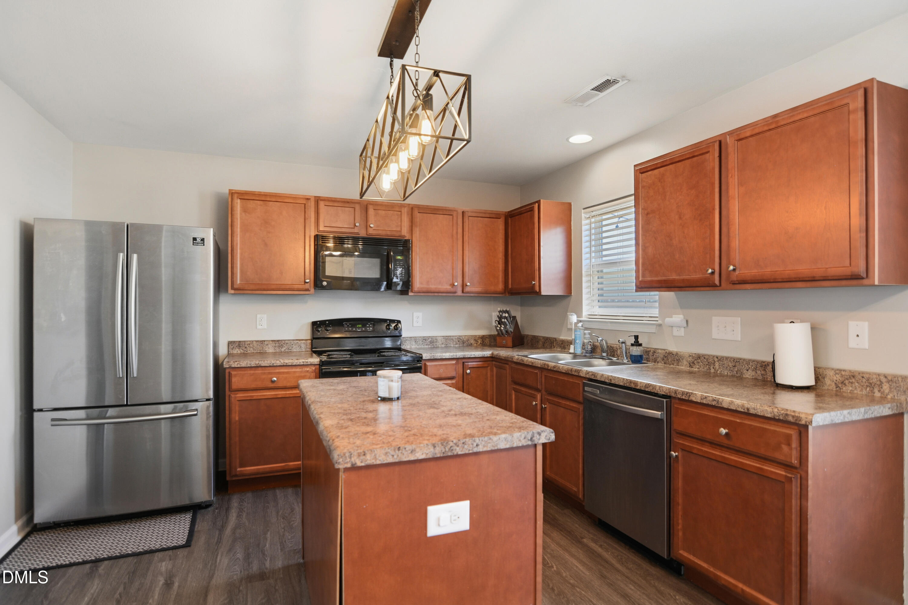 Undisclosed Address Durham, NC 27704 - Photo 6 of 21 a kitchen with stainless steel appliances granite countertop a refrigerator a sink a stove a microwave and wooden cabinets