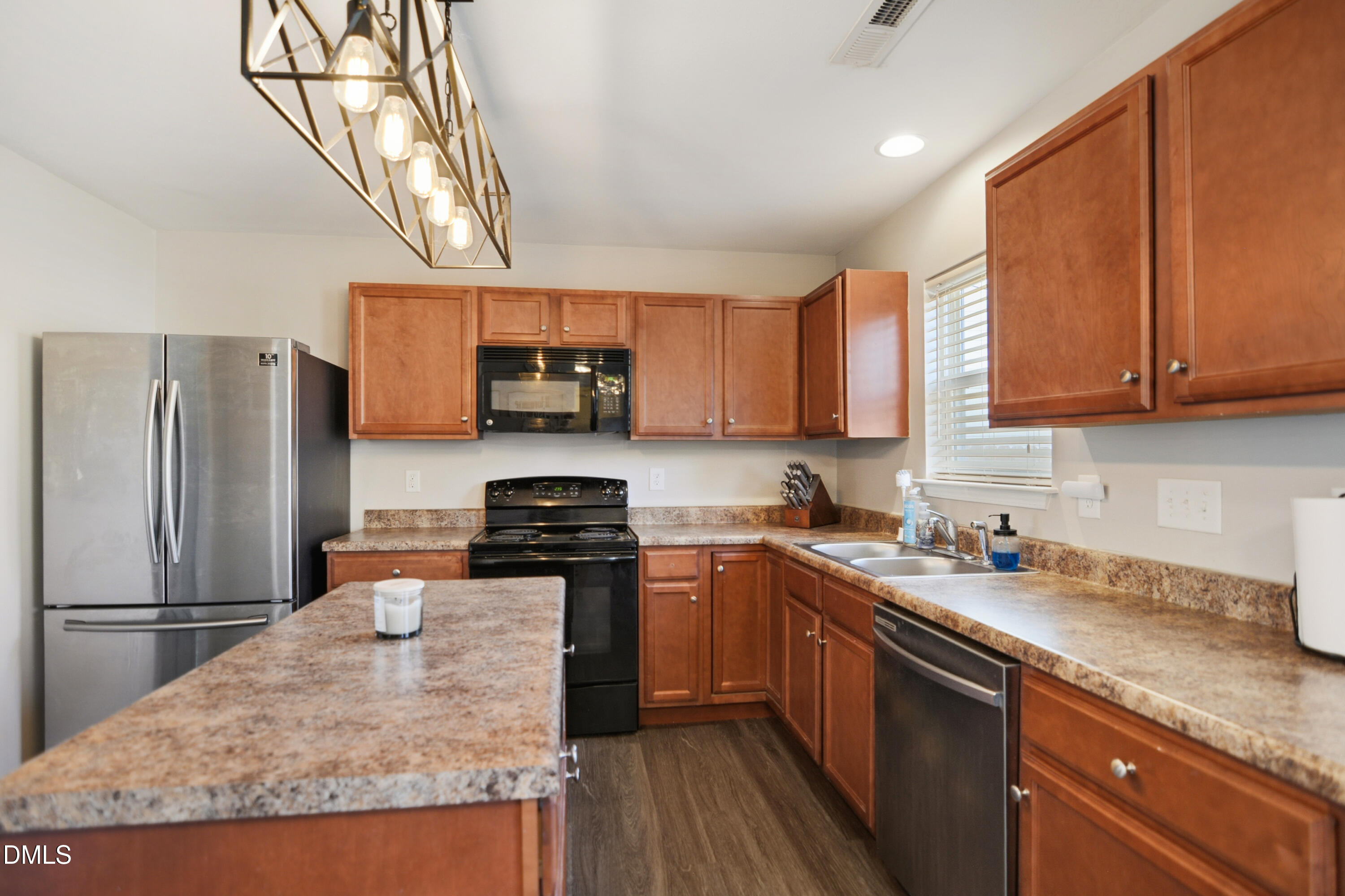 Undisclosed Address Durham, NC 27704 - Photo 7 of 21 a kitchen with stainless steel appliances granite countertop a stove a sink dishwasher a refrigerator and a microwave oven with wooden cabinets