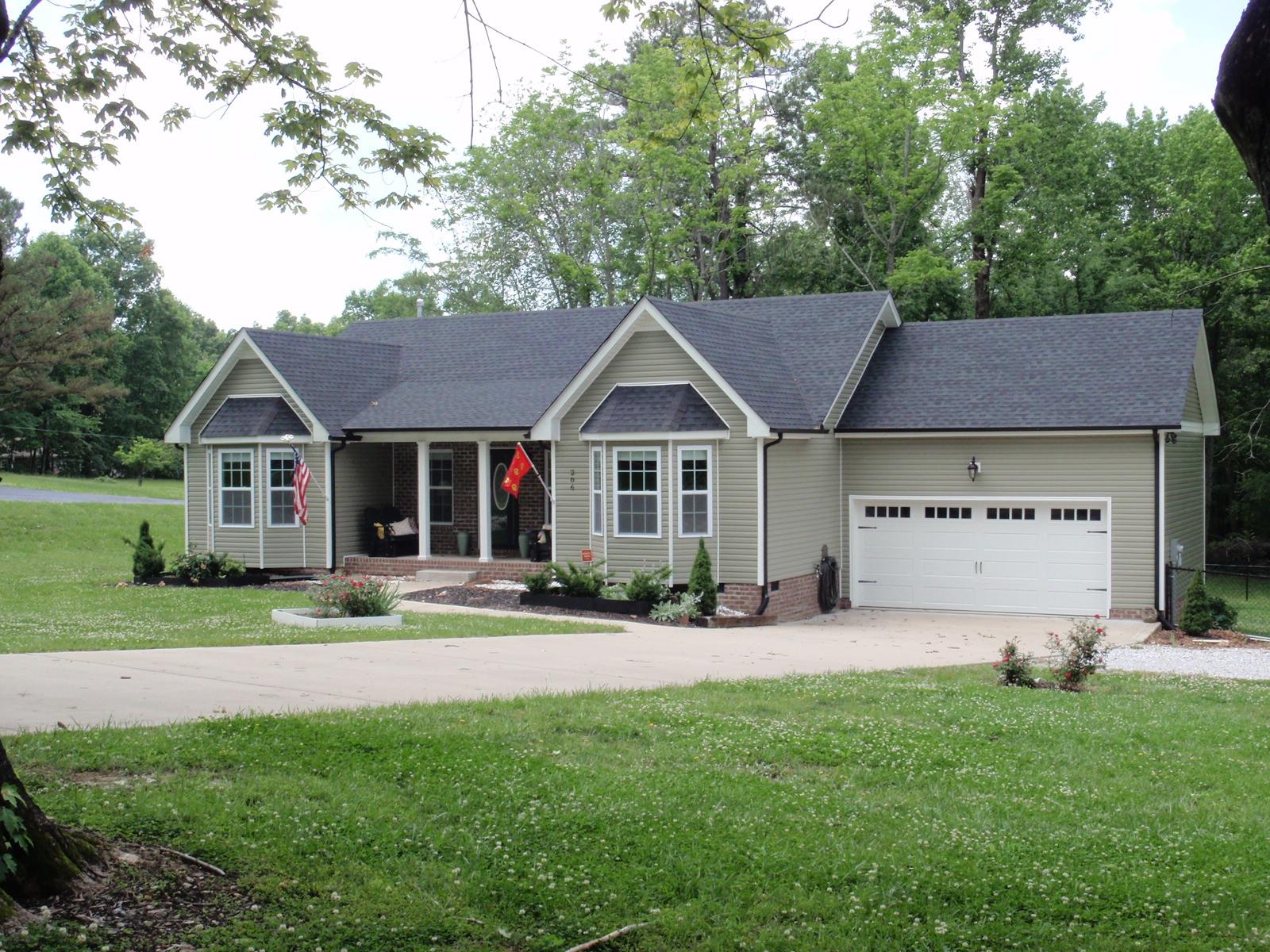 206 Black Road Dickson, TN 37055 - Photo 1 of 22 a front view of a house with a yard and garage
