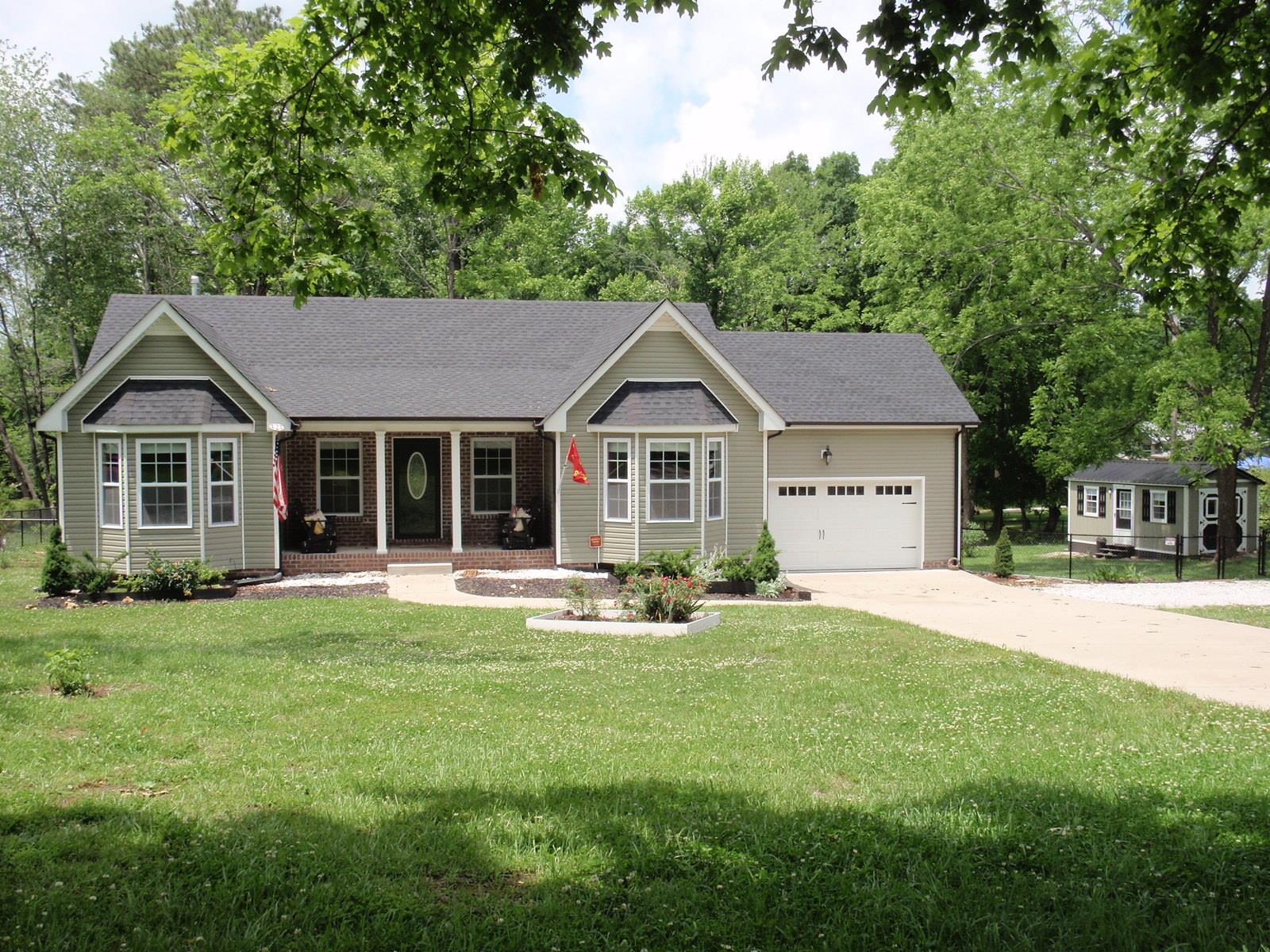 206 Black Road Dickson, TN 37055 - Photo 2 of 22 a front view of a house with a yard and trees