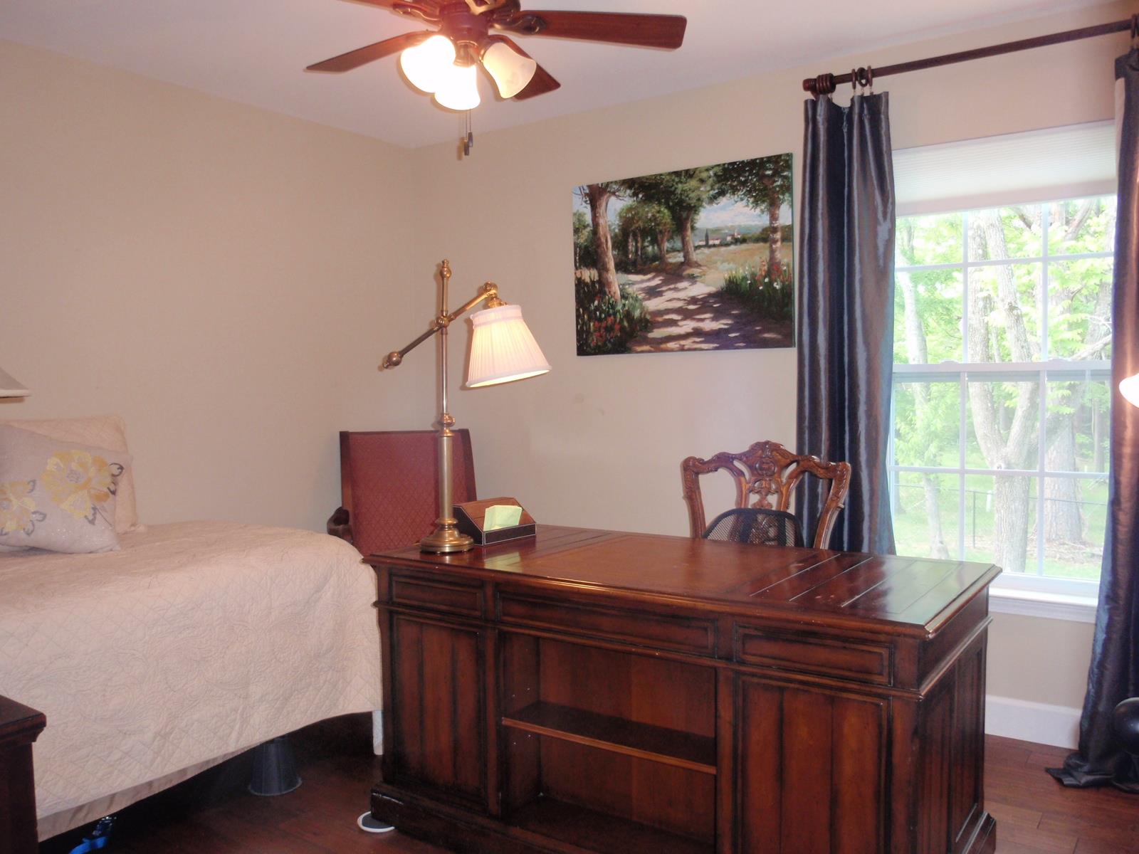 206 Black Road Dickson, TN 37055 - Photo 22 of 22 a bedroom with a large bed and a chandelier