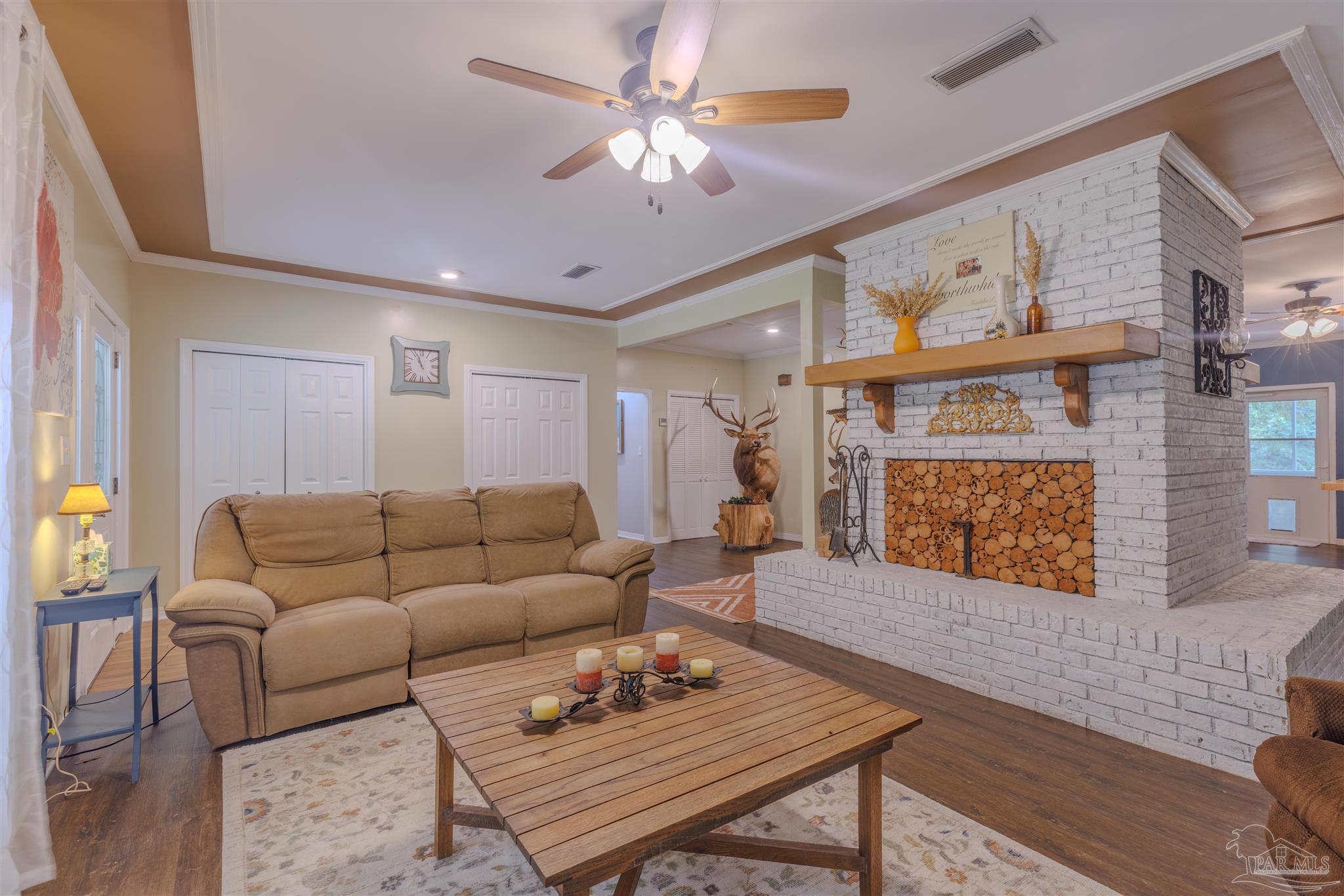 5049 Guernsey Road Pace, FL 32571 - Photo 16 of 61 a living room with furniture and a fireplace